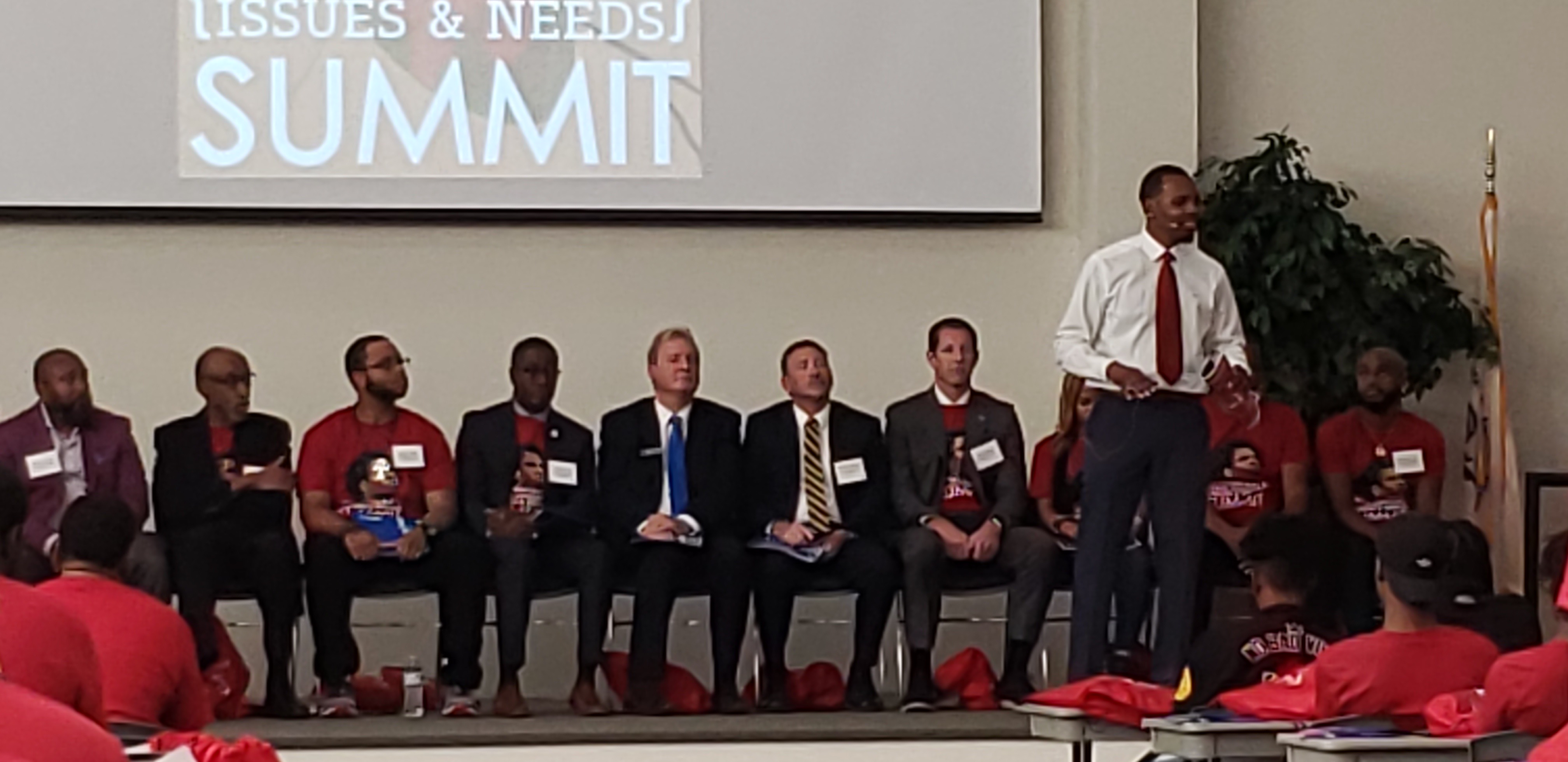 Joshua Burney emceeing the Issues & Needs Summit panel